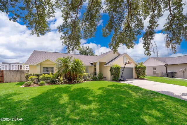 single story home featuring central air condition unit, a garage, and a front yard