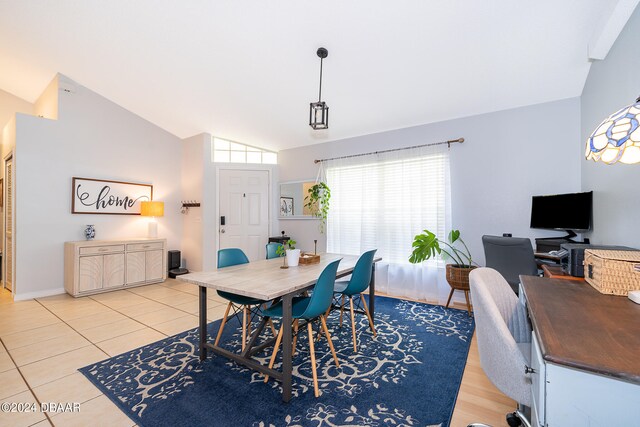 dining space with light wood-type flooring and high vaulted ceiling