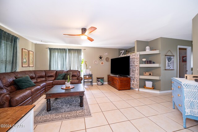 tiled living room with ceiling fan