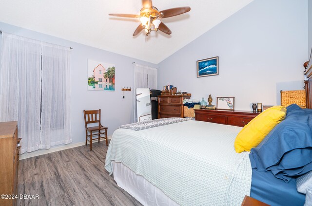 bedroom featuring light hardwood / wood-style floors, ceiling fan, and vaulted ceiling