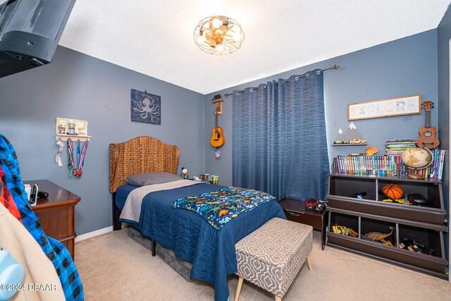 carpeted bedroom with a textured ceiling and vaulted ceiling