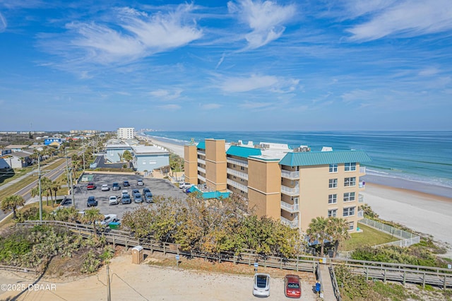 bird's eye view with a water view and a beach view