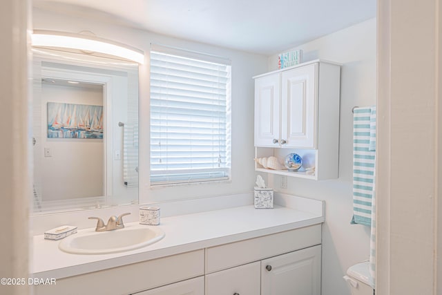 bathroom featuring vanity and toilet