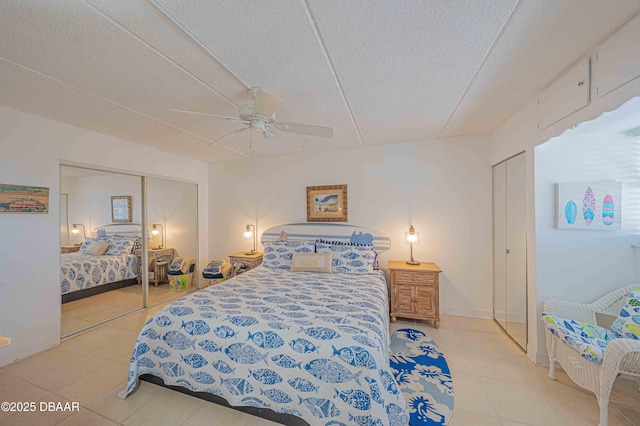 bedroom featuring ceiling fan, tile patterned floors, and a textured ceiling