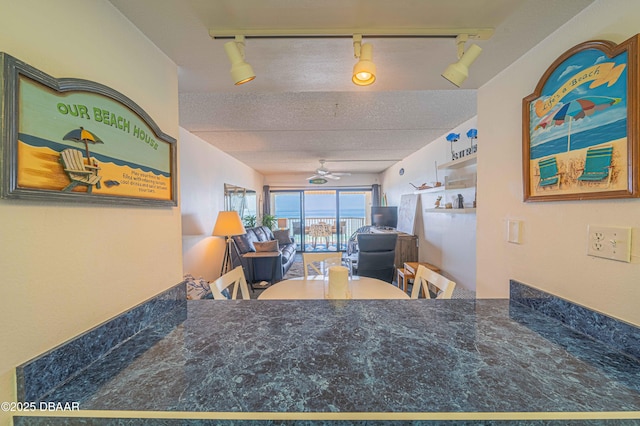 interior space featuring ceiling fan and a textured ceiling