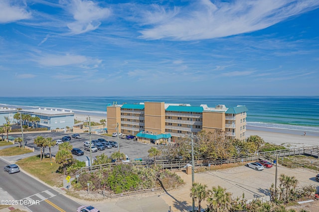 birds eye view of property with a view of the beach and a water view