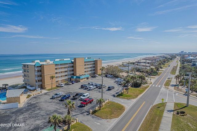 birds eye view of property featuring a water view and a beach view