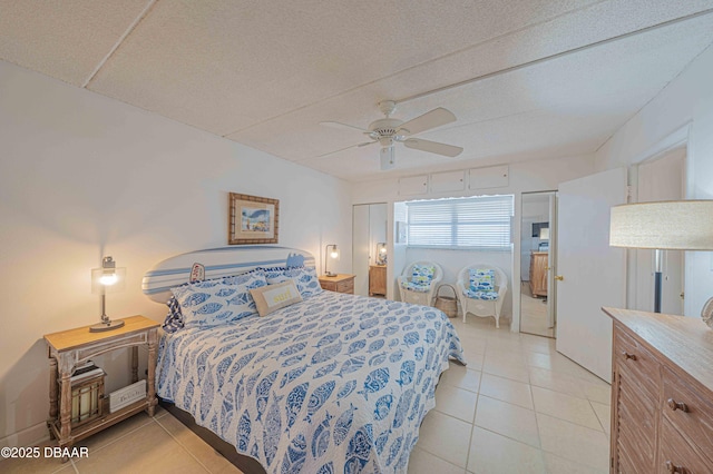 bedroom featuring light tile patterned floors and ceiling fan