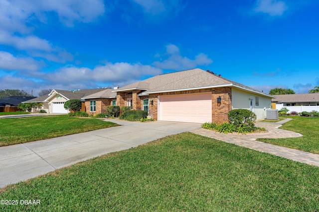 ranch-style house featuring a garage, central AC unit, and a front lawn