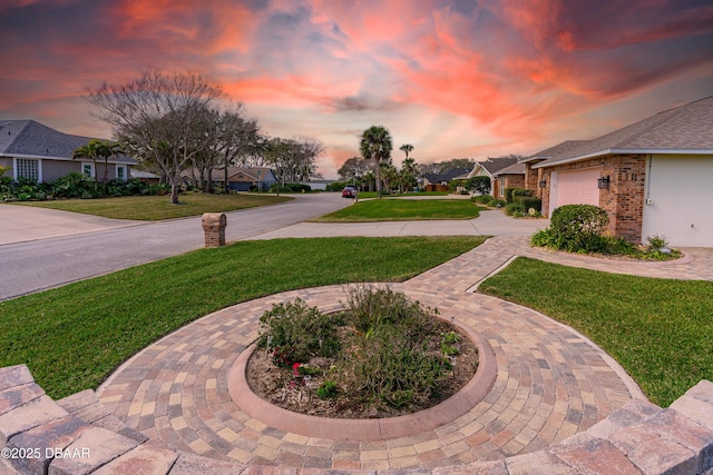 yard at dusk with a garage