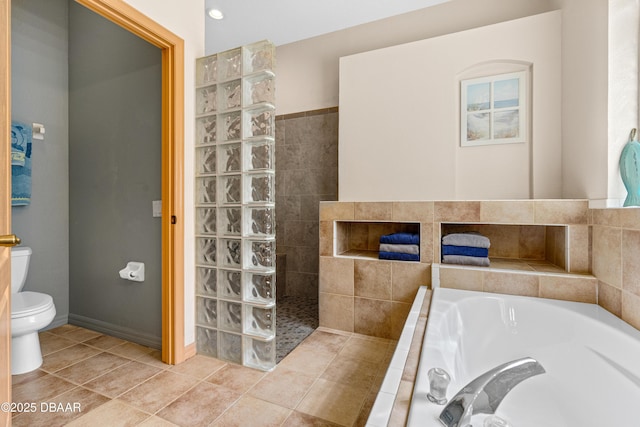 full bath featuring tile patterned floors, a walk in shower, toilet, and a garden tub