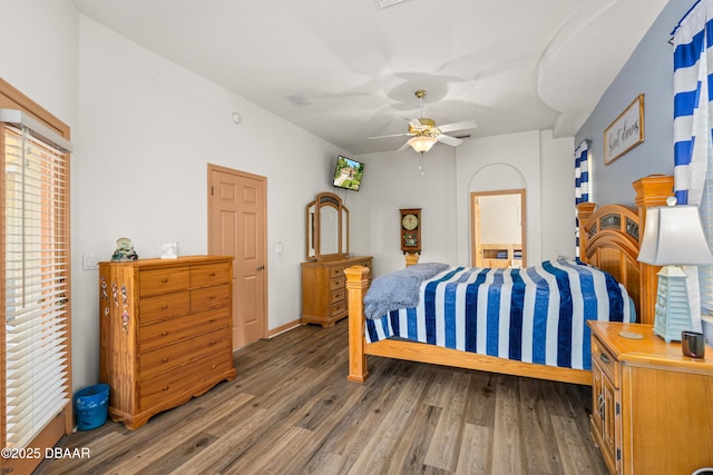 bedroom featuring ceiling fan, wood finished floors, and baseboards