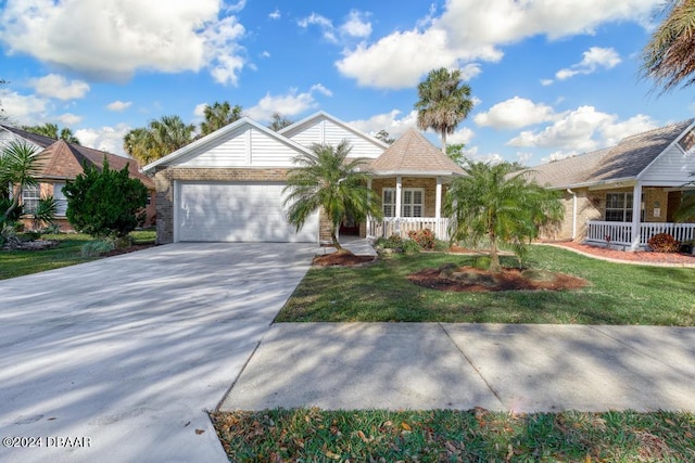 view of front of property featuring a front yard, a garage, and covered porch