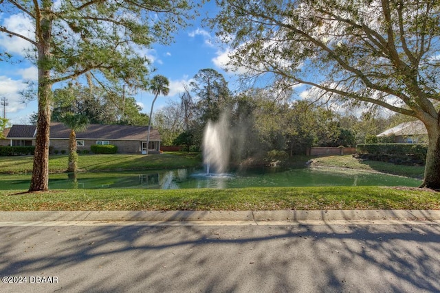 exterior space with a lawn and a water view