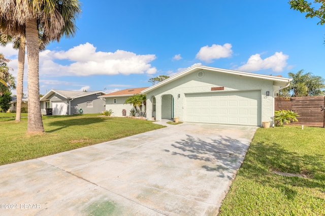 single story home featuring a front lawn and a garage