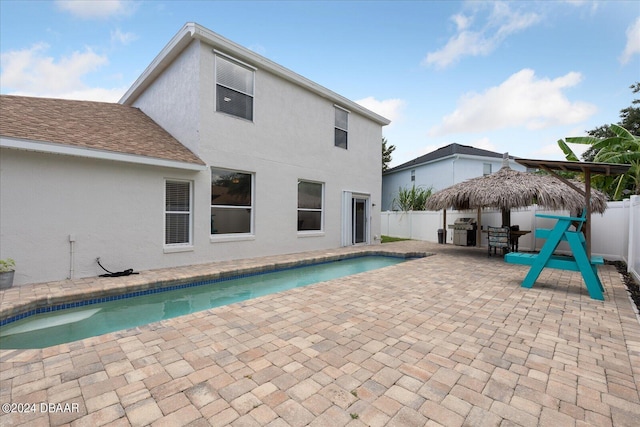 view of swimming pool with a fenced backyard, area for grilling, a fenced in pool, and a patio