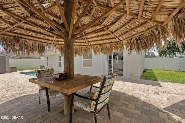 view of patio with a gazebo, outdoor dining area, a fenced in pool, and fence private yard