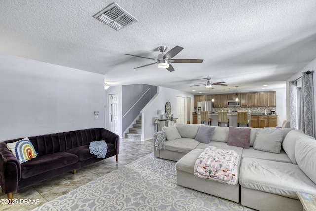 61 Levee Ln, Ormond Beach, FL 32174 - living area with stairway, a ceiling fan, and a textured ceiling