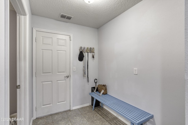 61 Levee Ln, Ormond Beach, FL 32174 - mudroom featuring a textured ceiling and light tile patterned floors