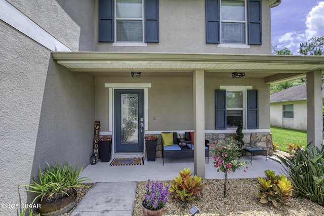 61 Levee Ln, Ormond Beach, FL 32174 - entrance to property with a porch and stucco siding