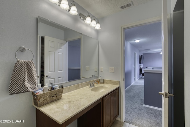 61 Levee Ln, Ormond Beach, FL 32174 - bathroom featuring a textured ceiling and vanity