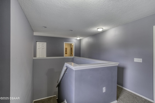 61 Levee Ln, Ormond Beach, FL 32174 - corridor with an upstairs landing, a textured ceiling, and carpet flooring