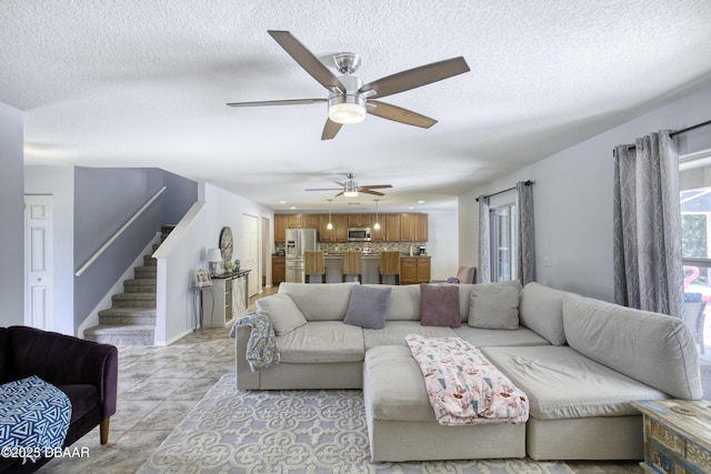 61 Levee Ln, Ormond Beach, FL 32174 - living room featuring stairs, a ceiling fan, a textured ceiling, and light tile patterned floors