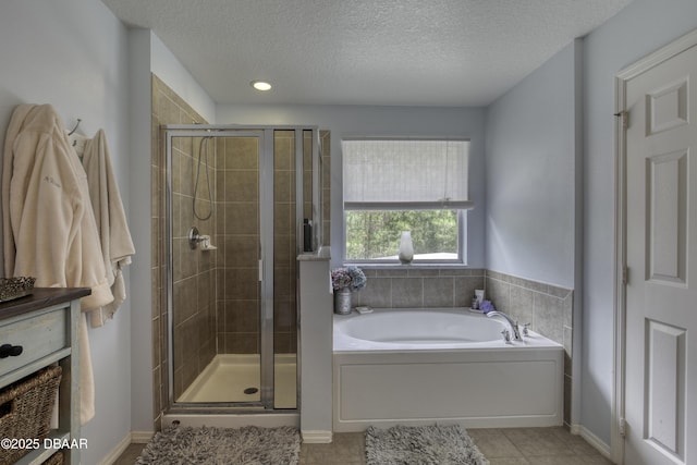 61 Levee Ln, Ormond Beach, FL 32174 - bathroom featuring a bath, a stall shower, a textured ceiling, tile patterned floors, and recessed lighting