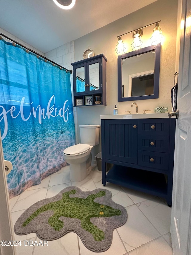 bathroom featuring vanity, toilet, and walk in shower