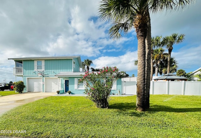 view of front of property with a garage and a front lawn