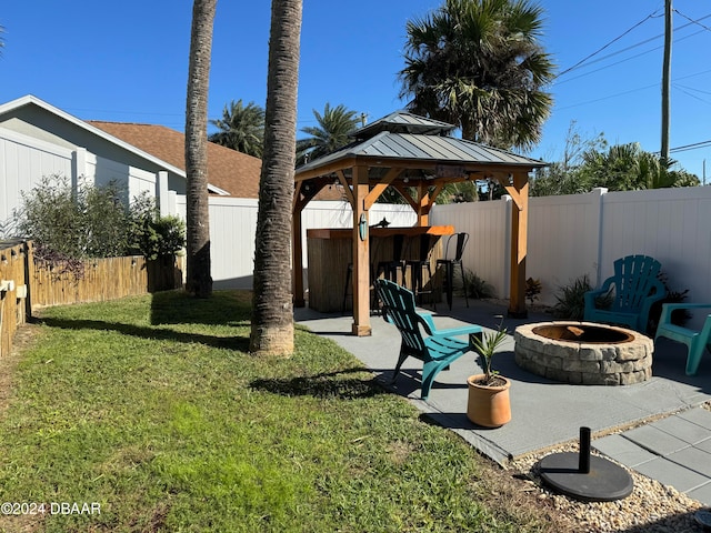 view of yard featuring a gazebo, a patio, exterior bar, and an outdoor fire pit