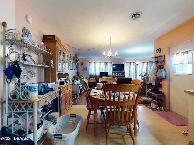 310 Legion Pl, Port Orange, FL 32129 - dining space with light wood-style flooring and a notable chandelier