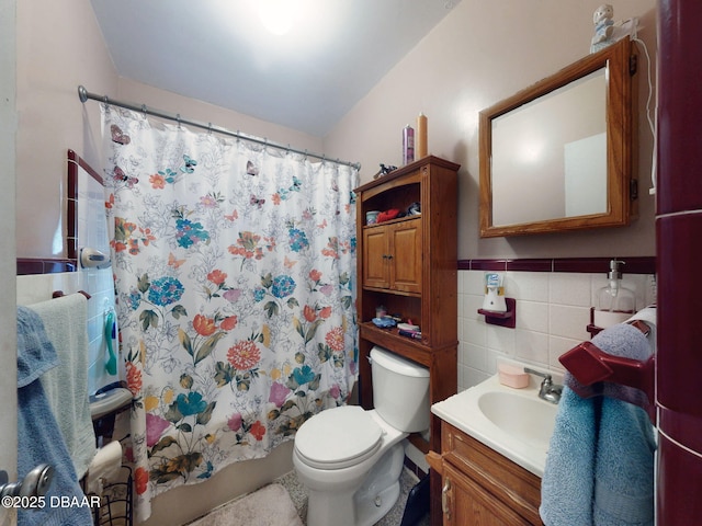 310 Legion Pl, Port Orange, FL 32129 - full bathroom featuring tile walls, vanity, toilet, shower / tub combo, and wainscoting