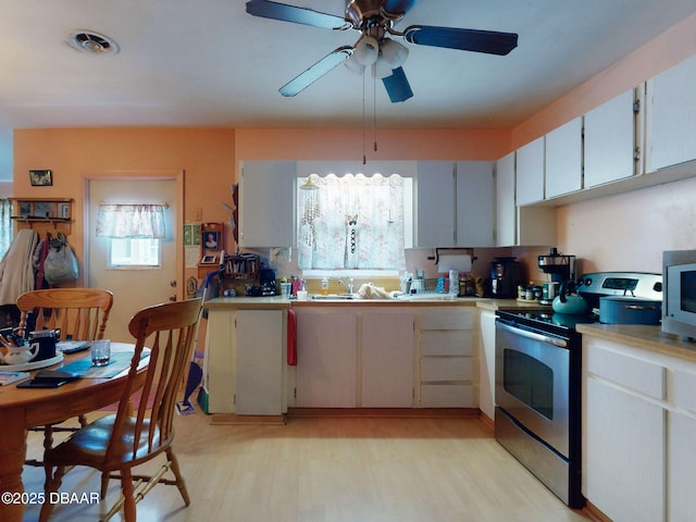 310 Legion Pl, Port Orange, FL 32129 - kitchen featuring a sink, ceiling fan, light wood-type flooring, light countertops, and appliances with stainless steel finishes