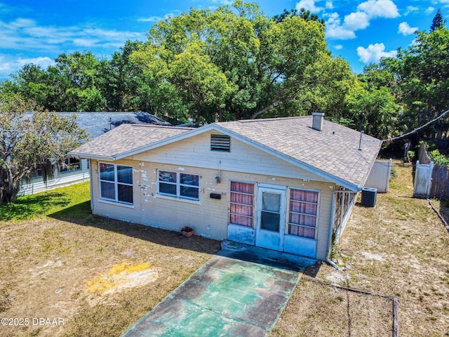 310 Legion Pl, Port Orange, FL 32129 - bungalow-style home featuring cooling unit, a front yard, a shingled roof, and fence