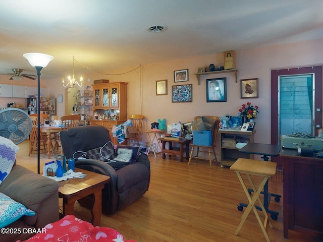 310 Legion Pl, Port Orange, FL 32129 - living area featuring wood finished floors and ceiling fan with notable chandelier
