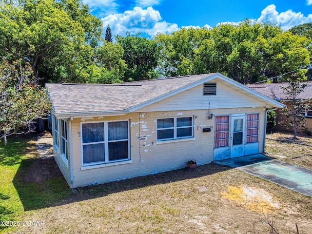310 Legion Pl, Port Orange, FL 32129 - bungalow-style house featuring a front lawn, brick siding, and roof with shingles