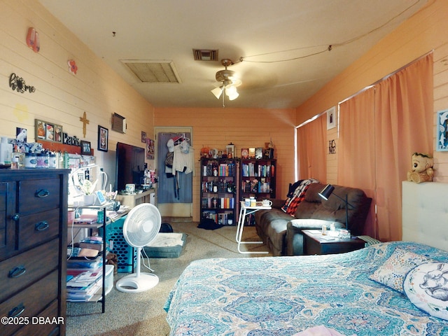 310 Legion Pl, Port Orange, FL 32129 - carpeted bedroom with wood walls, visible vents, and a ceiling fan