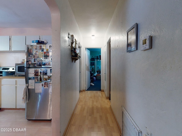 310 Legion Pl, Port Orange, FL 32129 - hall featuring arched walkways, visible vents, a textured wall, and light wood-type flooring