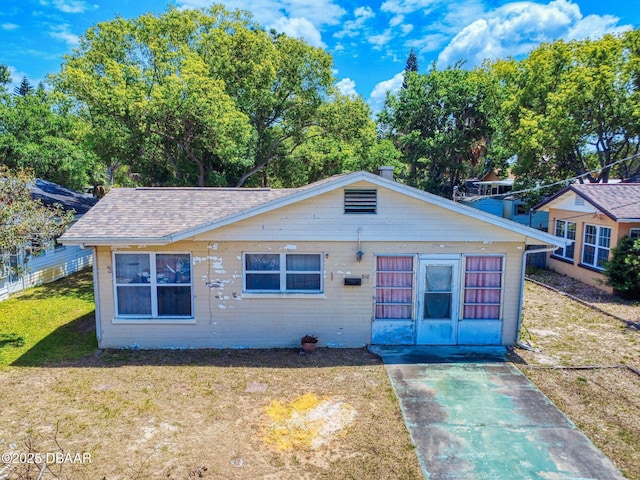 310 Legion Pl, Port Orange, FL 32129 - bungalow-style home with a front lawn and a shingled roof