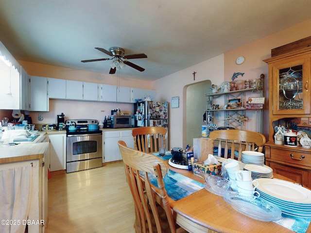 310 Legion Pl, Port Orange, FL 32129 - dining room featuring a ceiling fan, light wood-style flooring, and arched walkways
