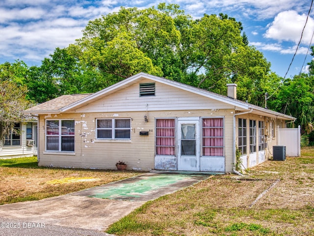310 Legion Pl, Port Orange, FL 32129 - bungalow-style house with a chimney, central AC, and a front yard