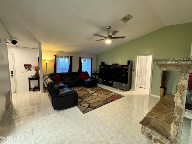 living room with a textured ceiling, lofted ceiling, and ceiling fan