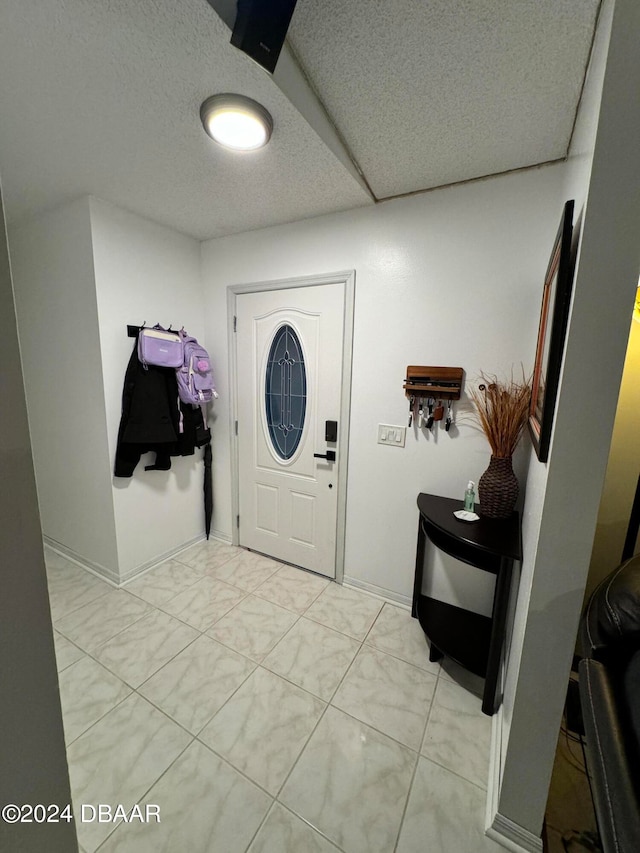 entryway with a textured ceiling