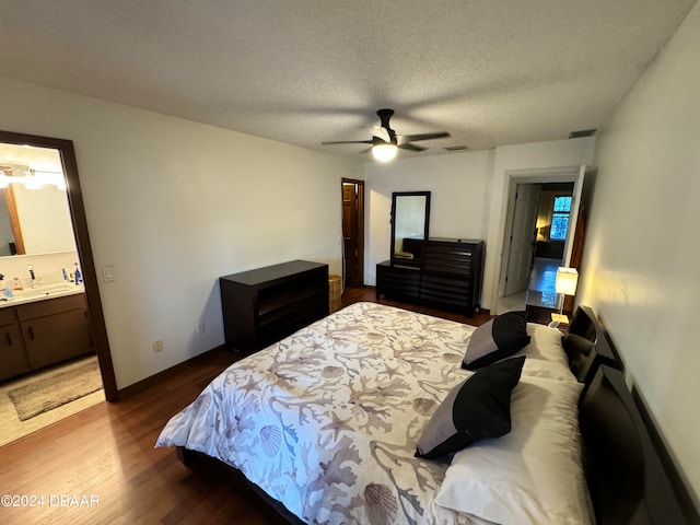 bedroom featuring ensuite bathroom, ceiling fan, a textured ceiling, and hardwood / wood-style flooring