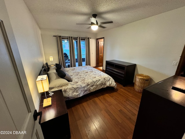 bedroom with a textured ceiling, hardwood / wood-style flooring, and ceiling fan