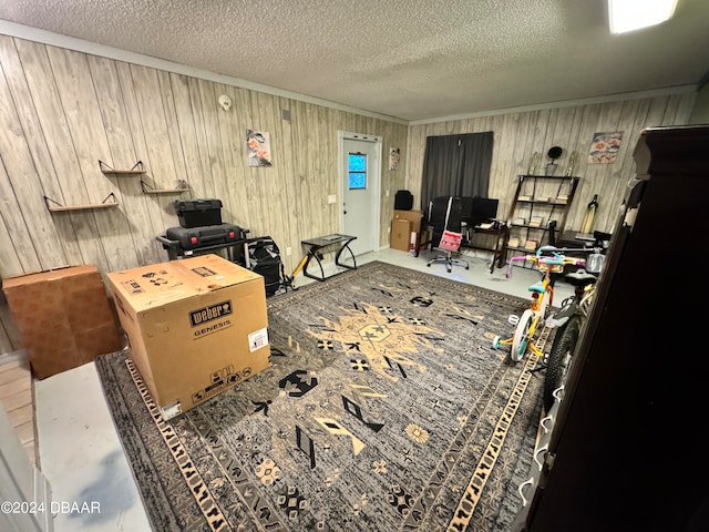 misc room featuring wooden walls and a textured ceiling