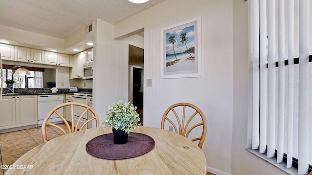 4655 46th Street Ct W Unit 101, Bradenton, FL 34210 - dining space featuring a textured ceiling, light tile patterned floors, and recessed lighting