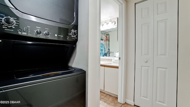 4655 46th Street Ct W Unit 101, Bradenton, FL 34210 - laundry room with stacked washer / dryer and light tile patterned floors