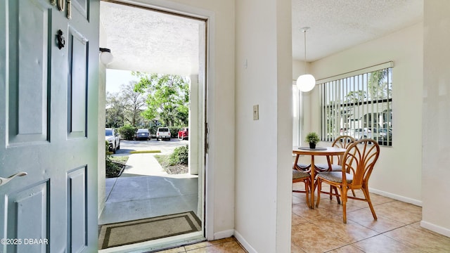 4655 46th Street Ct W Unit 101, Bradenton, FL 34210 - entrance foyer featuring a textured ceiling and light tile patterned floors